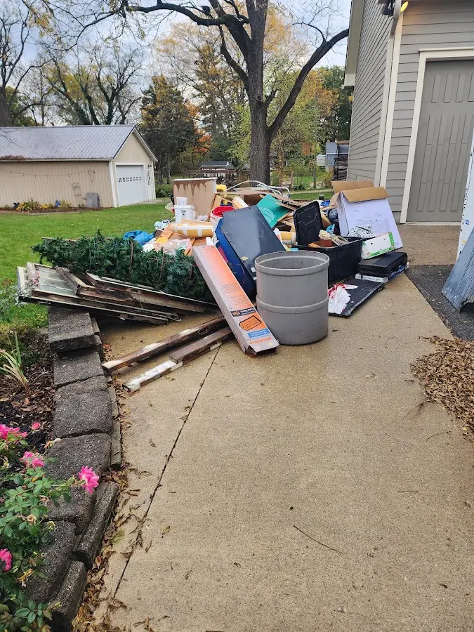 Dumpster being loaded with debris for Estate Cleanout Dumpster Rental in Potomac Mills